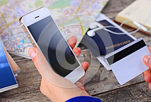 Close-up woman's hands holding a credit card and using cell phone