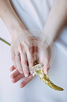 Close-up of a woman's hands holding a flower