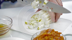 Close-up woman`s hands slicing pear on chopping board in a kitchen. cooking healthy food.