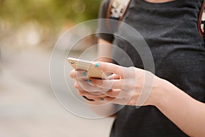 Close up of woman`s hands texting with smartphone