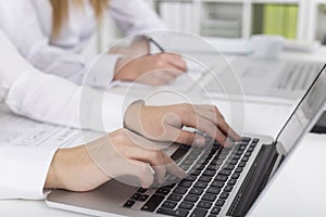 Close up of woman`s hands typing