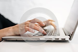 Close up woman& x27;s hands typing on laptop keyboard at home office. Businesswoman or student girl using pc for online