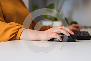 close up of a woman's hands working on a desktop computer in the office