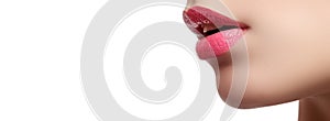 Close-up of woman`s lips with bright fashion pink glossy makeup