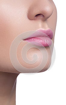 Close-up of woman's lips with bright fashion pink glossy makeup. Macro magenta lipgloss make-up.