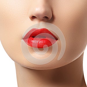 Close-up of woman`s lips with bright fashion red glossy makeup