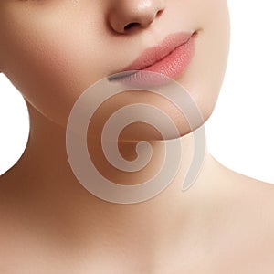 Close-up of woman's lips with fashion natural beige lipstick mak