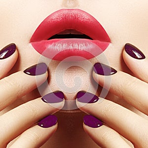 Close-up of woman`s Lips with Fashion pink Make-up and Manicure on Nails. Beautiful female full lips with perfect Makeup