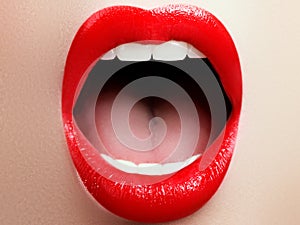 Close-up of woman`s lips with fashion red make-up. Beautiful female mouth, full lips with perfect makeup