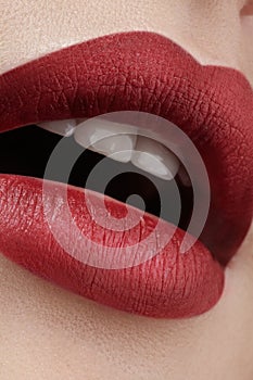 Close-up of woman's lips with fashion red make-up. Beautiful female mouth, full lips with perfect makeup. Classic visage