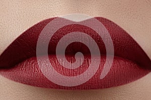 Close-up of woman's lips with fashion red make-up. Beautiful female mouth, full lips with perfect makeup. Classic visage