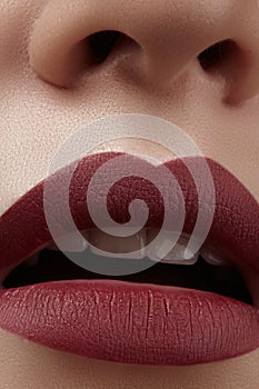 Close-up of woman's lips with fashion red make-up. Beautiful female mouth, full lips with perfect makeup. Classic visage