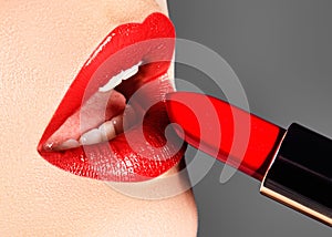 Close-up of woman`s lips with fashion red make-up. Macro shot of beautiful make up on full lips. Choice lipstick