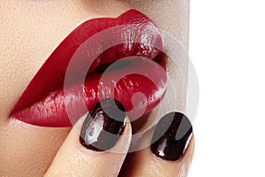 Close-up of woman's lips with fashion red make-up, nails. Beauty surgery, cosmetology