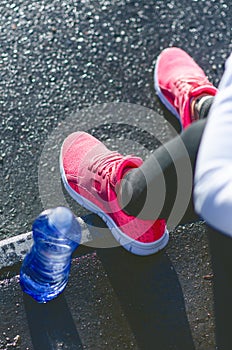 Close up of womanÂ´s sports shoes. Young woman have a rest on stairs. Healthy lifestyle. Fitness sport. Cardio training.