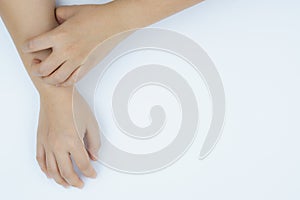 Close up woman scratching her itchy arm with allergy rash by hand on white background. Healthcare, skin problem and medical