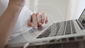 Close up of woman scrolling with trackpad on laptop.