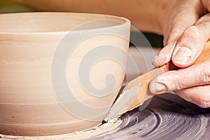 Close-up of a woman sculpts clay vase