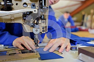 close up woman sewing machine operator