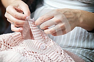 Close up woman sews a button