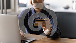 Close up of woman shopping online with credit card