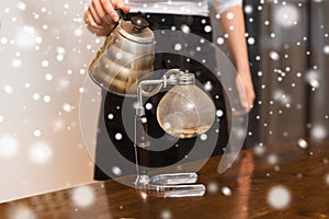 Close up of woman with siphon coffee maker and pot