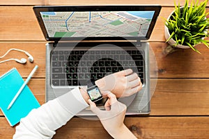 Close up of woman with smart watch and laptop