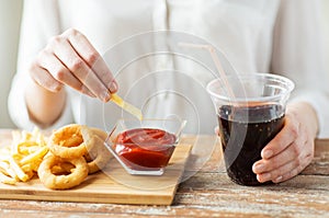 Close up of woman with snacks and cocacola