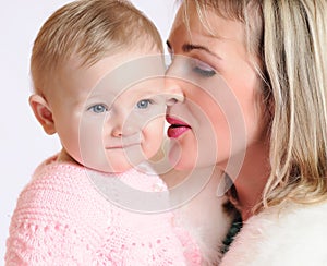 Close-up of a woman snuggling nose to a child
