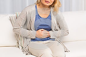 Close up of woman suffering from stomach ache photo