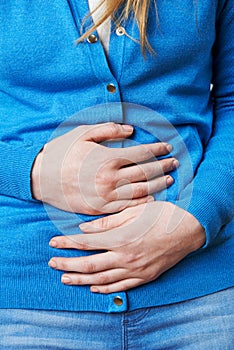Close Up Of Woman Suffering With Stomach Pain