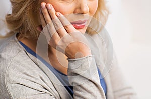 Close up of woman suffering toothache at home