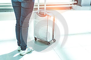 Close up woman and suitcase trolley luggage in airport. People a