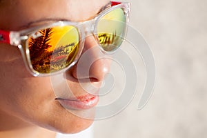 Close up of Woman In Sunglasses With Beach Reflection