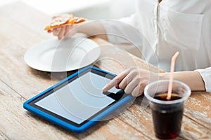 Close up of woman with tablet pc having dinner