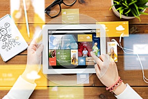 Close up of woman with tablet pc on wooden table