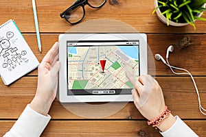 Close up of woman with tablet pc on wooden table