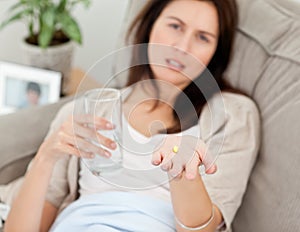 Close up of a woman taking her medicine