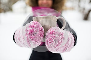 Close up of woman with tea mug outdoors in winter