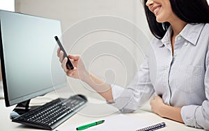 Close up of woman texting on smartphone at office