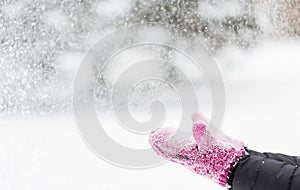 Close up of woman throwing snow outdoors