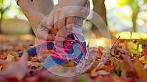 Close up of woman is tying shoe laces and running.