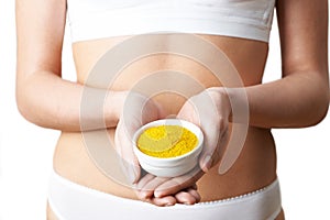 Close Up Of Woman In Underwear Holding Dish Of Tumeric