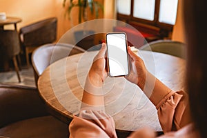 Close up of woman using cell phone,sending massages on the coffee shop