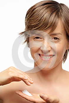 Close up of woman using cream