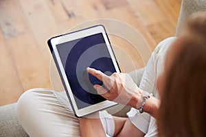 Close Up Of Woman Using Digital Tablet At Home