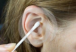 Close up, Woman using Ear cotton swabs. Hygienic ears sticks