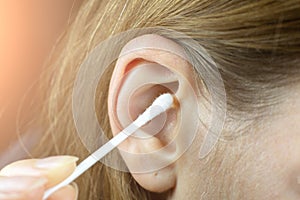 Close up, Woman using Ear cotton swabs. Hygienic ears sticks