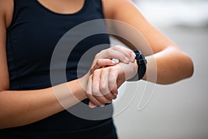 Close-up of woman using fitness smart watch device before running