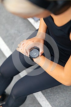 Close-up of woman using fitness smart watch device before running